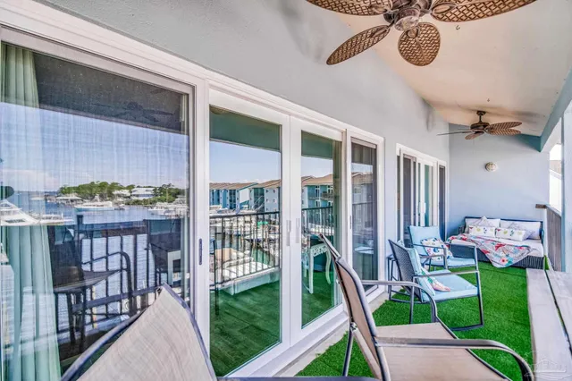 a balcony with lots of potted plants and wooden fence