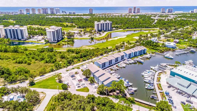 an aerial view of water body with boats and residential houses with outdoor space