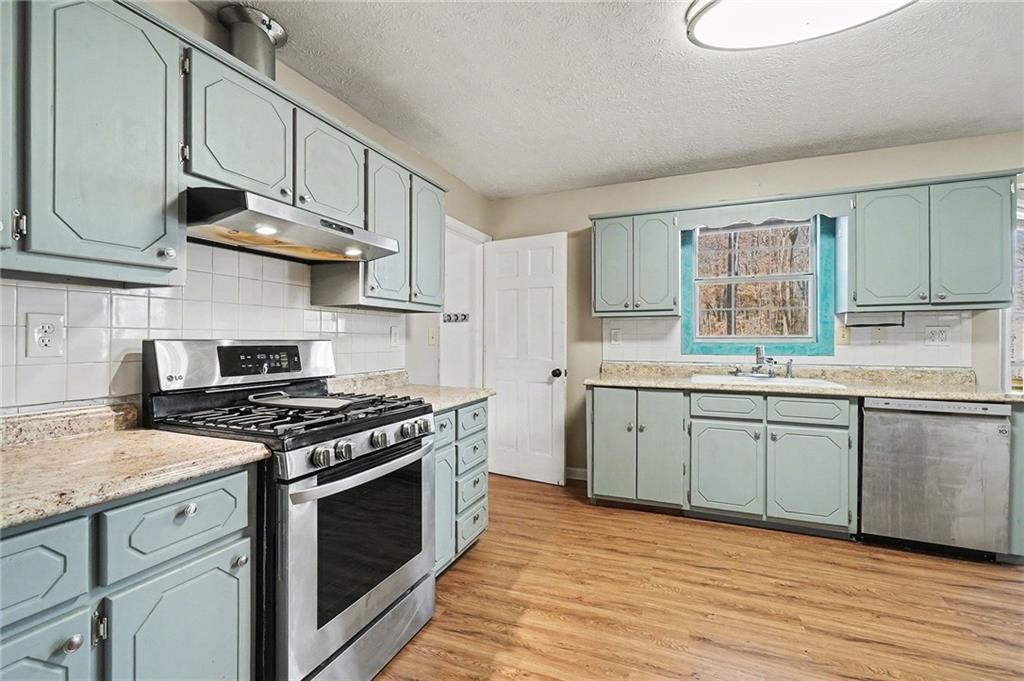 5295 Ridge Road Douglasville, GA 30134 - Photo 11 of 35 a kitchen with stainless steel appliances granite countertop a stove and a sink