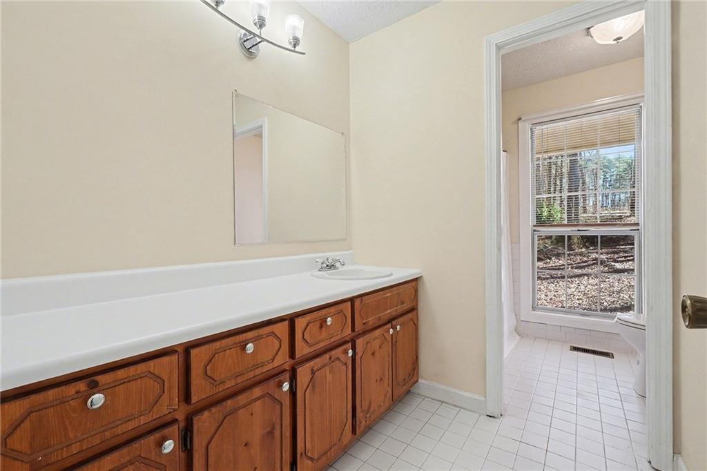5295 Ridge Road Douglasville, GA 30134 - Photo 14 of 35 a bathroom with a sink a vanity and a large mirror