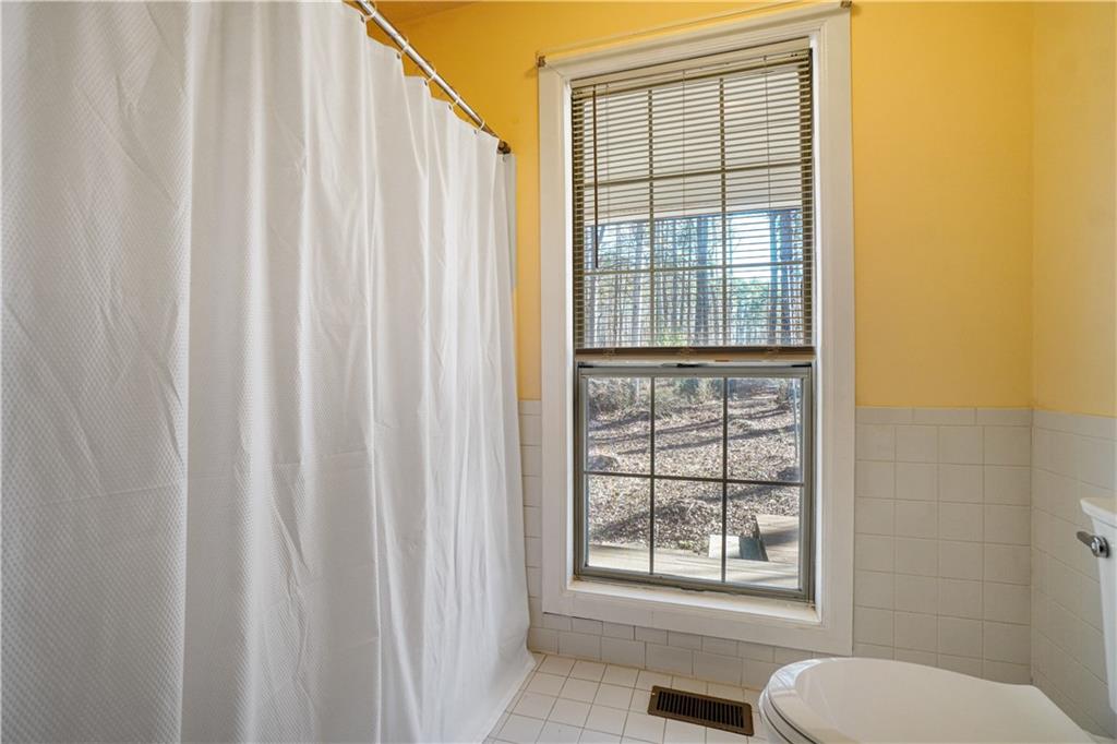 5295 Ridge Road Douglasville, GA 30134 - Photo 15 of 35 a bathroom with a toilet a sink and a window