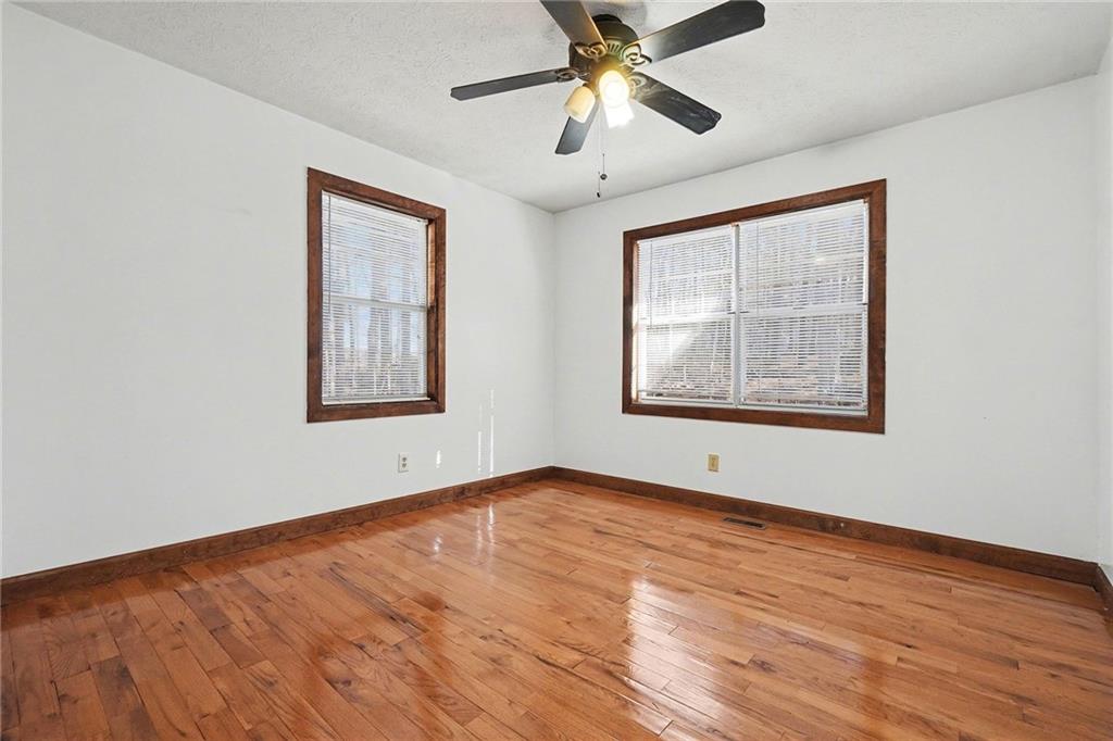 5295 Ridge Road Douglasville, GA 30134 - Photo 16 of 35 a view of an empty room with wooden floor and a window