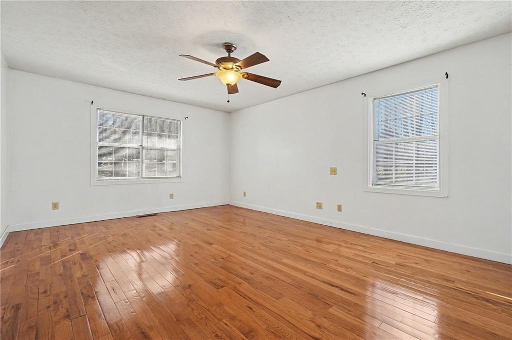 5295 Ridge Road Douglasville, GA 30134 - Photo 17 of 35 a view of an empty room with a window and wooden floor