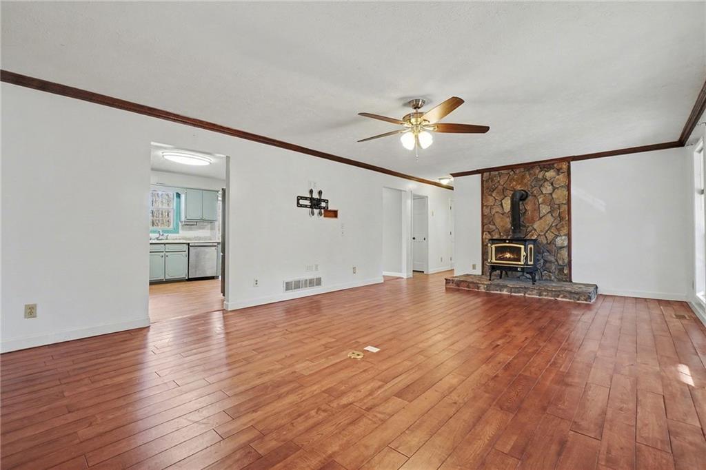 5295 Ridge Road Douglasville, GA 30134 - Photo 9 of 35 a view of a livingroom with furniture wooden floor and a ceiling fan