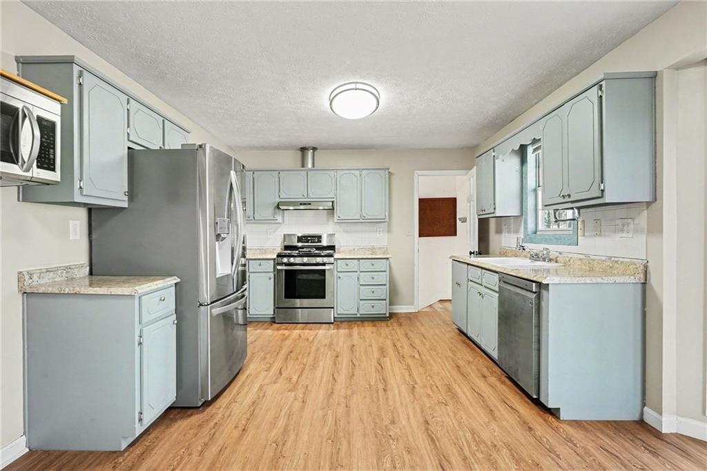 5295 Ridge Road Douglasville, GA 30134 - Photo 10 of 35 a kitchen with stainless steel appliances granite countertop a refrigerator stove and sink
