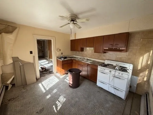 a kitchen with a stove a sink and a refrigerator
