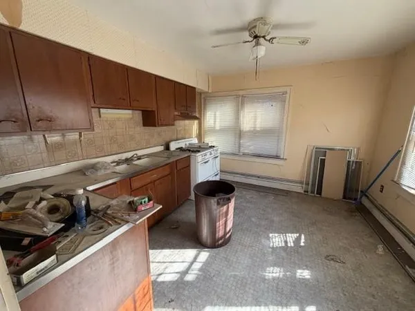 a kitchen with a sink stove and cabinets