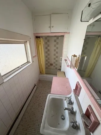 a bedroom with a bed and a mirror