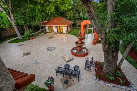 an outdoor view of the house with swimming pool and lounge chairs