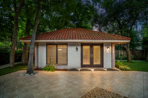 a front view of a house with yard porch and furniture