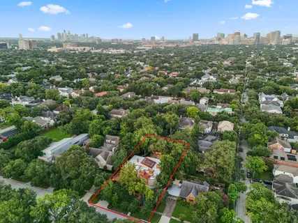 an aerial view of residential houses with city view