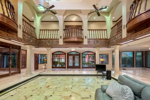 a living room with lots of furniture and a chandelier