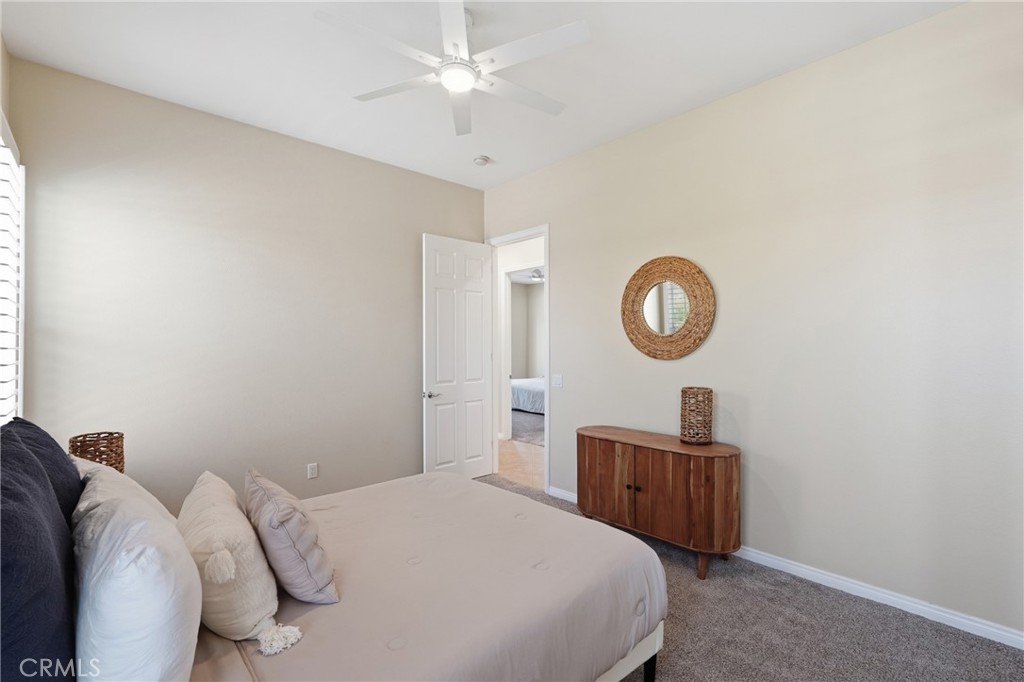 9 Orleans Road Rancho Mirage, CA 92270 - Photo 35 of 71 a bedroom with a bed and a chandelier