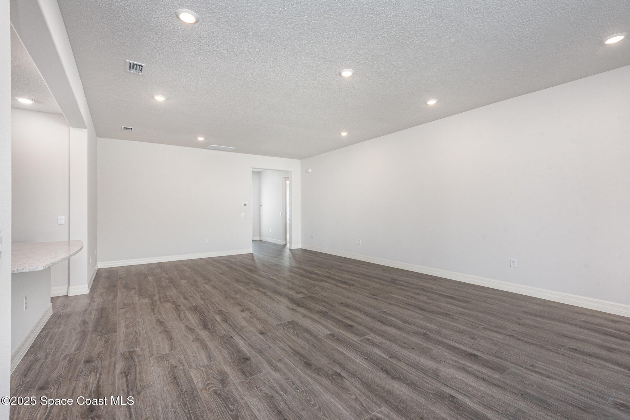 245 1st Street Cocoa, FL 32922 - Photo 6 of 34 a view of an empty room with wooden floor