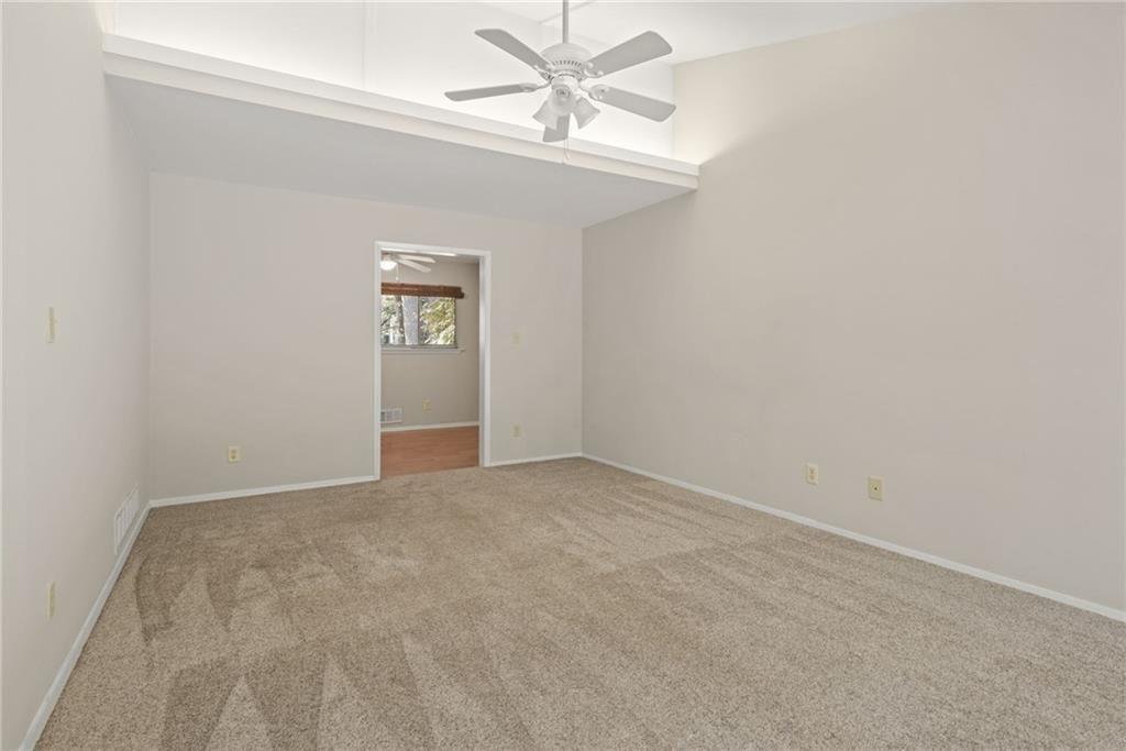 705 Edgewater Trail Sandy Springs, GA 30328 - Photo 19 of 36 an empty room with windows and fan