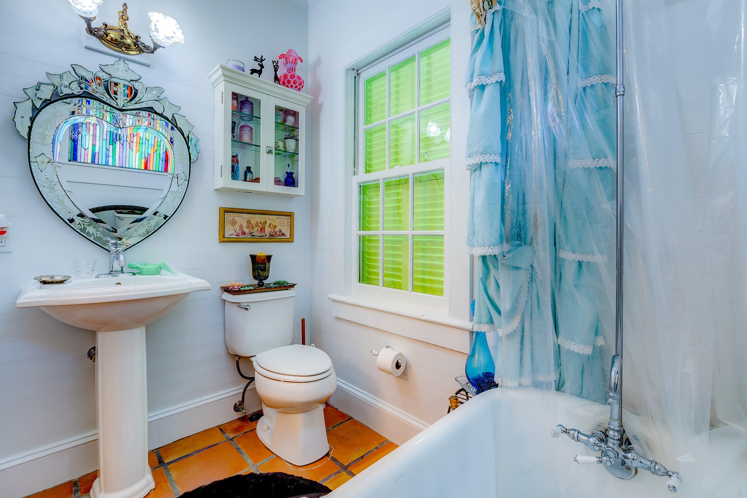 908 Windsor Lane Key West, FL 33040 - Photo 3 of 3 a bathroom with a sink a toilet and a mirror