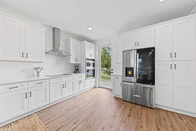 a kitchen with stainless steel appliances a refrigerator sink and cabinets