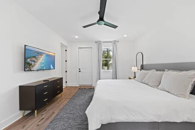 a bedroom with a large bed and a chandelier