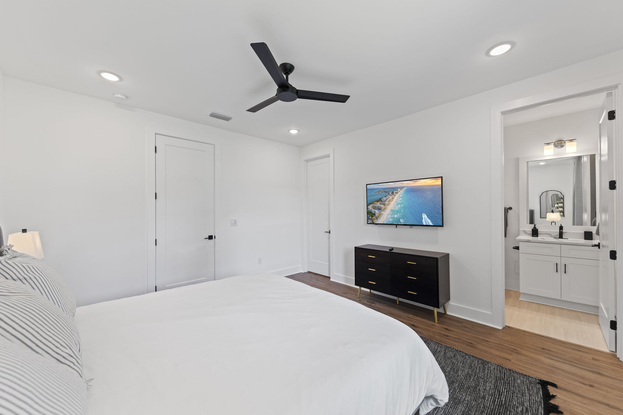 50 Blue Eden Loop, Unit LOT 39 Santa Rosa Beach, FL 32459 - Photo 21 of 46 a spacious bedroom with a bed and a fireplace