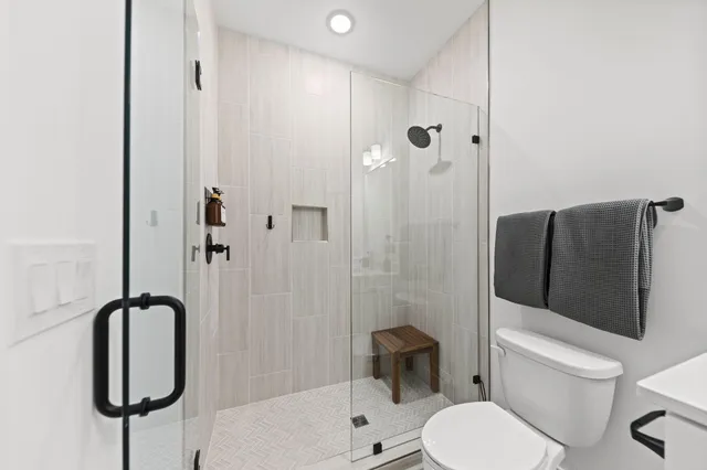 a white toilet sitting next to a bathroom sink
