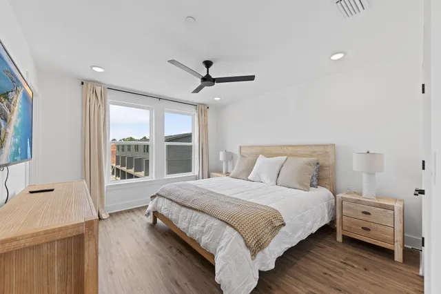 a bedroom with a large bed and a large window