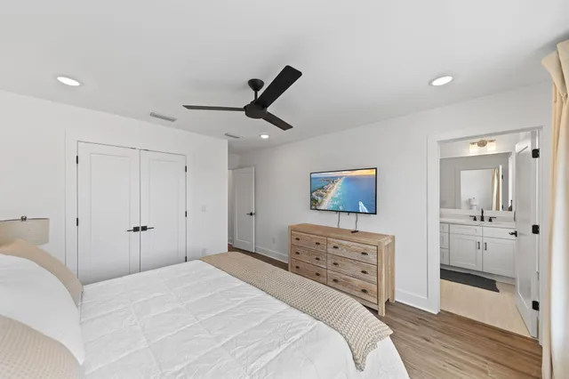 a bedroom with a bed and a painting on the wall