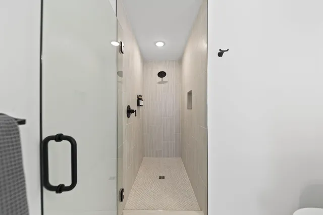 a bedroom with a large bed and a chandelier