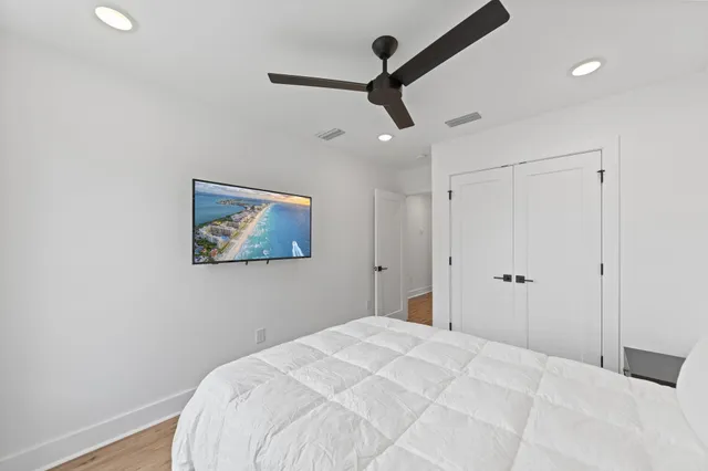 a large bed sitting in a bedroom next to a window