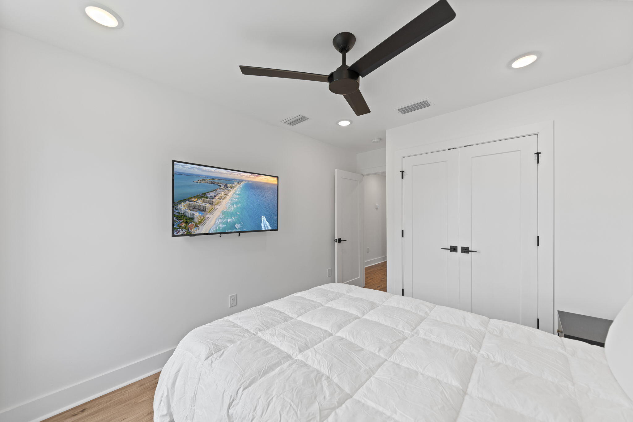 50 Blue Eden Loop, Unit LOT 39 Santa Rosa Beach, FL 32459 - Photo 28 of 46 a bedroom with a large bed and a chandelier