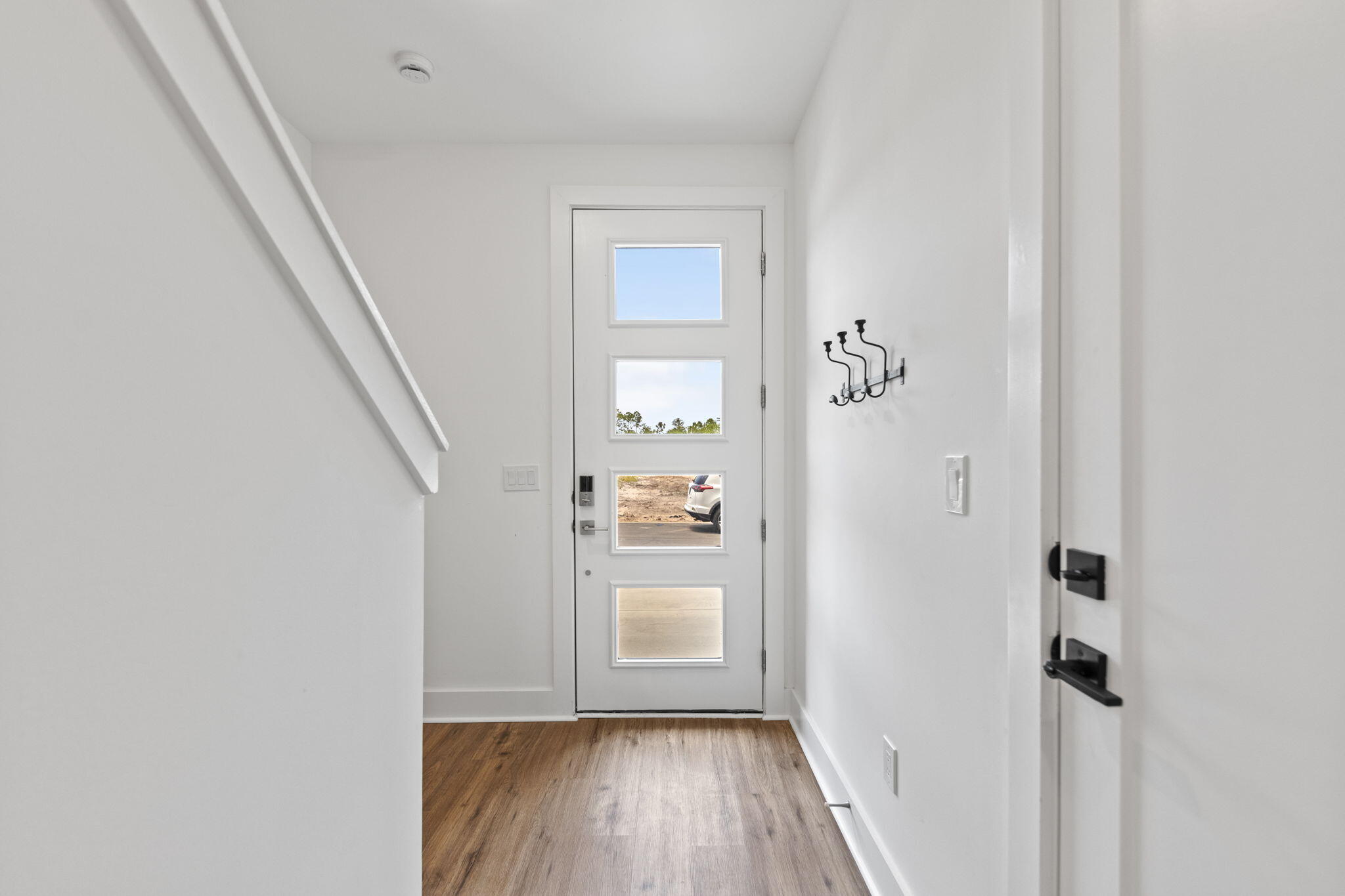 50 Blue Eden Loop, Unit LOT 39 Santa Rosa Beach, FL 32459 - Photo 37 of 46 a view of a hallway with wooden floor and stairs