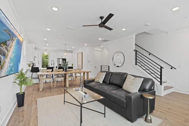 a living room with furniture a rug and white walls