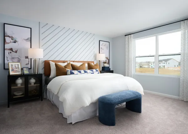 a bed sitting in a bedroom next to a window