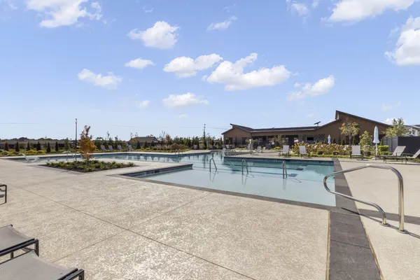 a view of swimming pool with outdoor seating and city view
