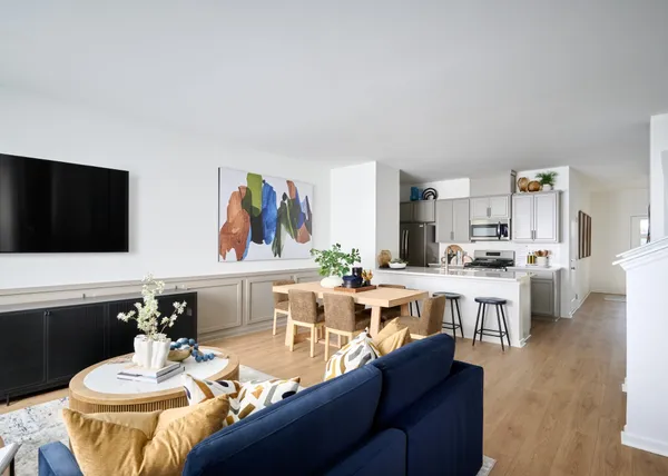 a living room with stainless steel appliances kitchen island granite countertop a dining table and chairs