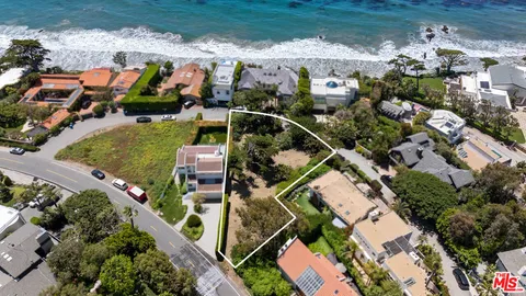 an aerial view of a house with a garden and outdoor space