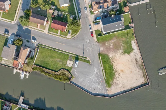 an aerial view of a house with a yard and lake view