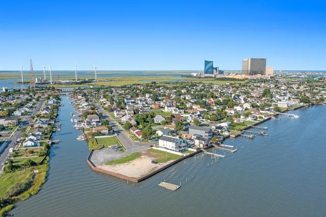 a view of a terrace with lawn chairs