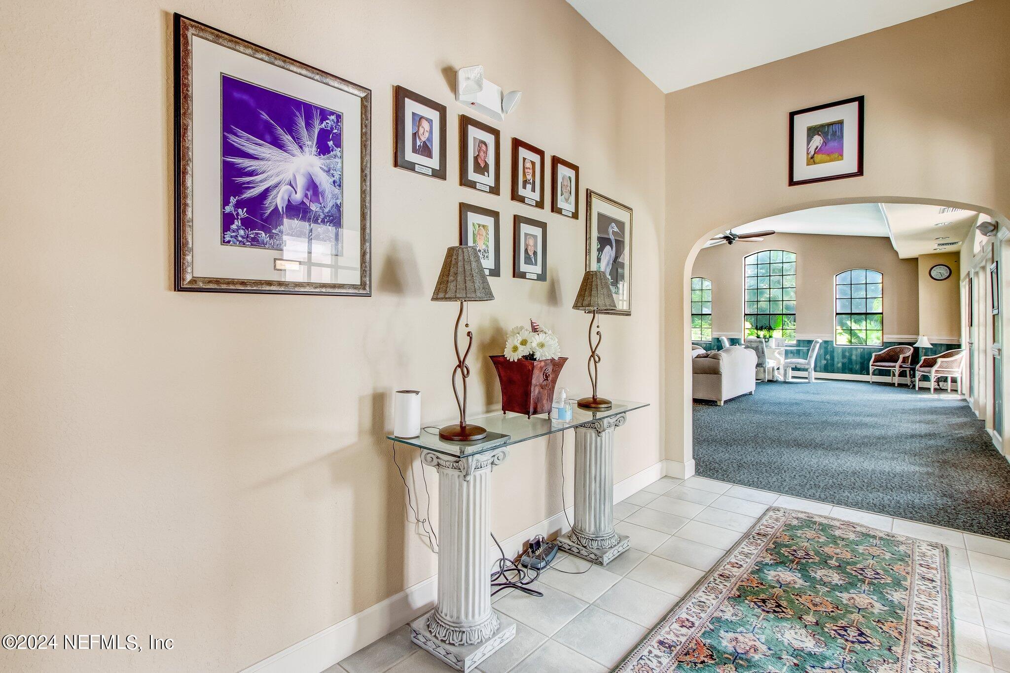 3302 Haley Pointe Road St. Augustine, FL 32084 - Photo 49 of 53 a view of a hallway with wooden floor and dining table