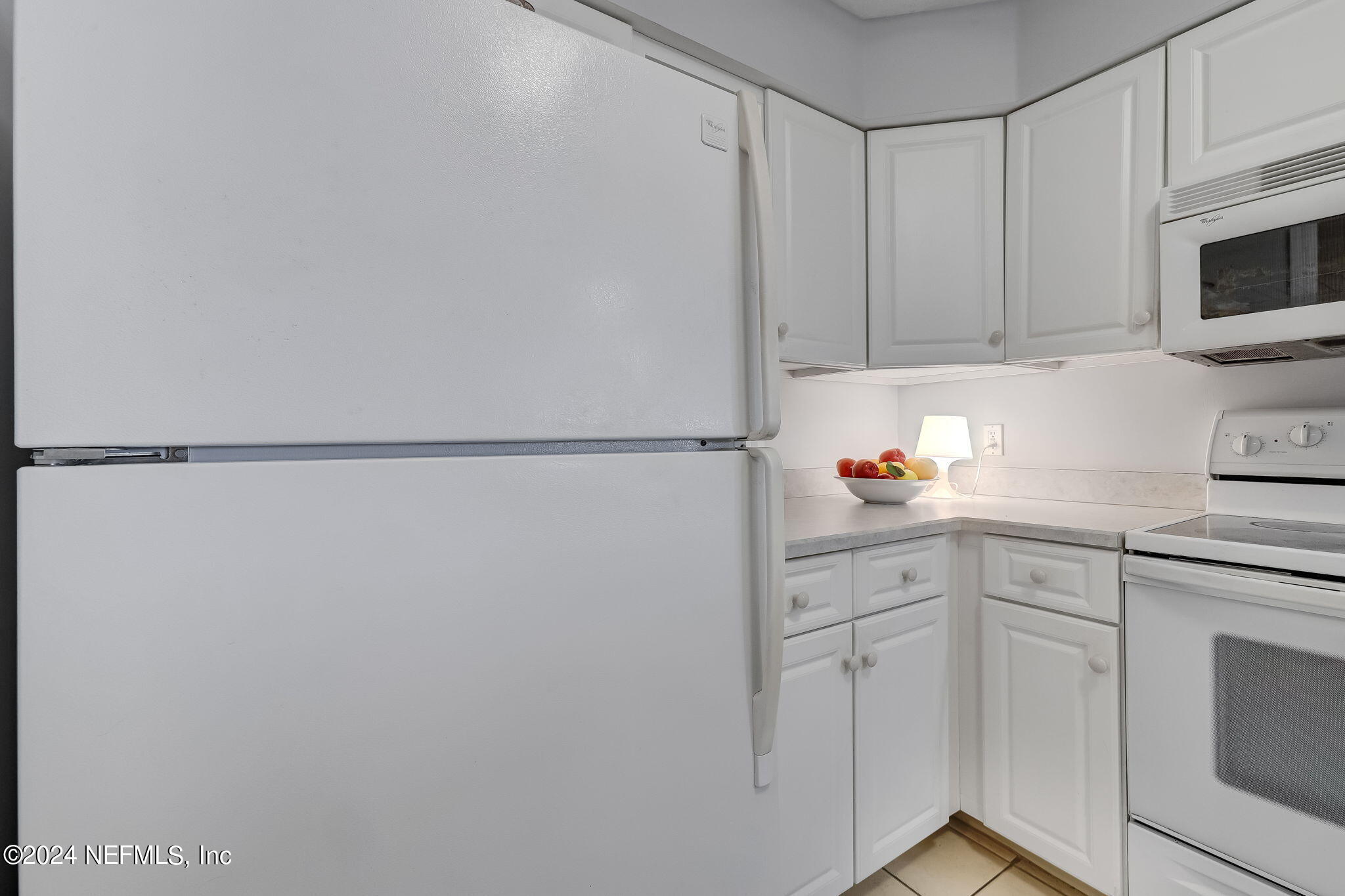 3302 Haley Pointe Road St. Augustine, FL 32084 - Photo 8 of 53 a kitchen with white cabinets and white appliances