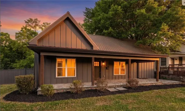 a front view of house with yard outdoor seating and barbeque oven