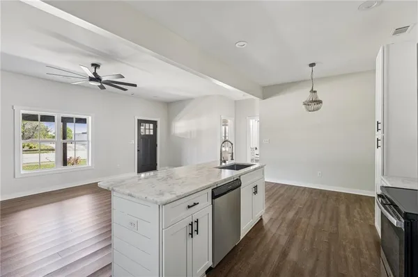 a kitchen with stainless steel appliances granite countertop a refrigerator and a sink