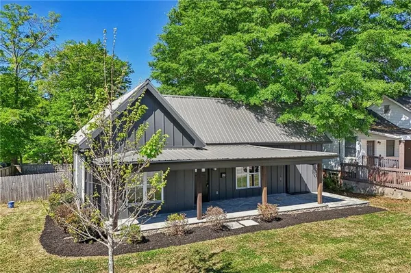 a view of house with yard outdoor seating and entertaining space
