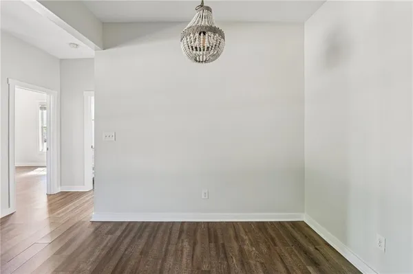 a view of a room with wooden floor