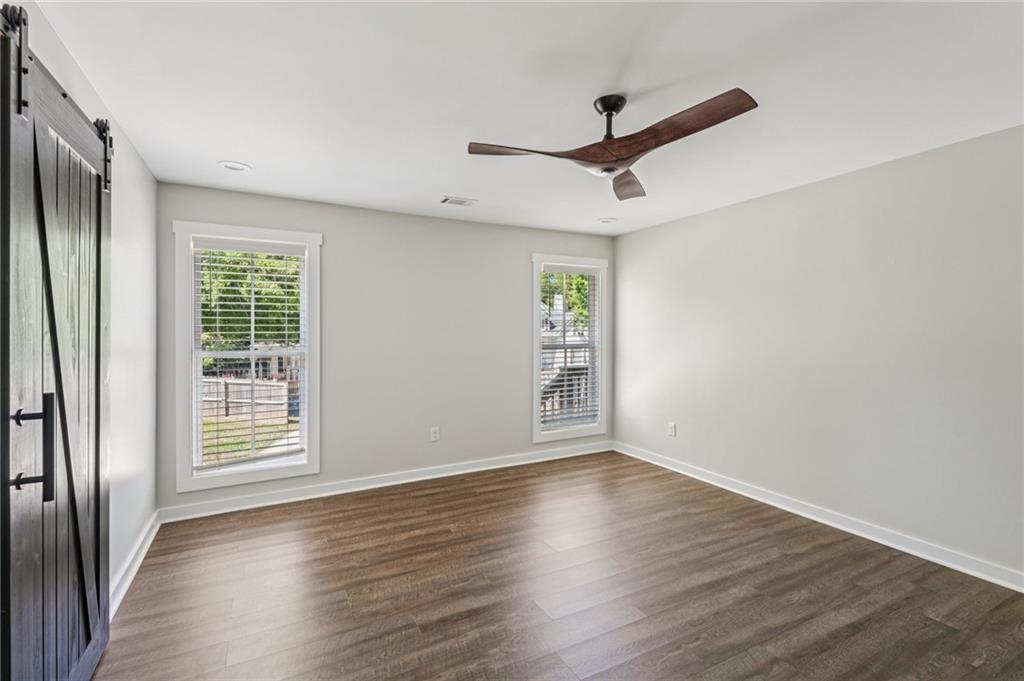 212 Hamilton Avenue Bremen, GA 30110 - Photo 27 of 65 a view of an empty room with wooden floor and a window