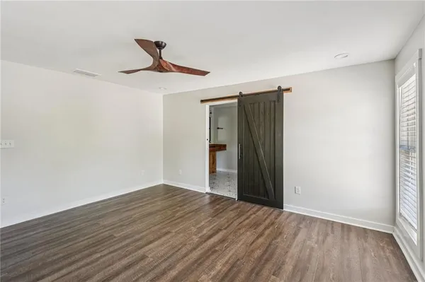 a room with table chairs and wooden floor