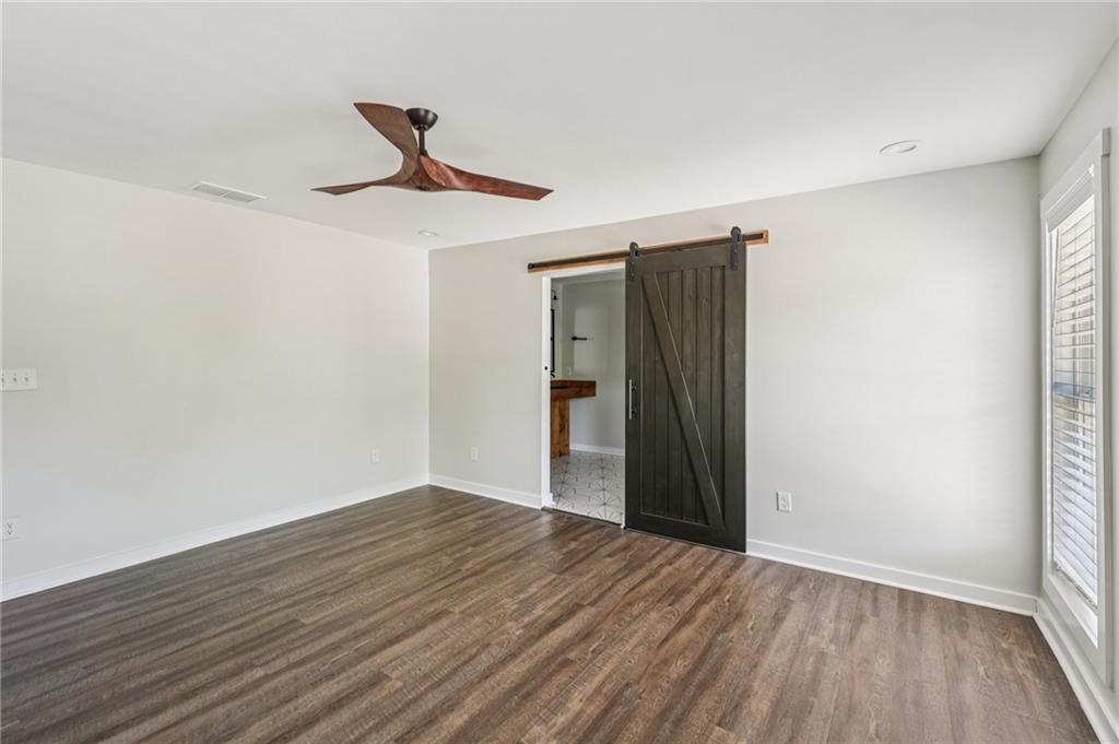 212 Hamilton Avenue Bremen, GA 30110 - Photo 29 of 65 a view of an empty room with wooden floor and a window