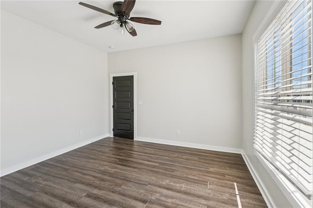 212 Hamilton Avenue Bremen, GA 30110 - Photo 42 of 65 a view of an empty room with wooden floor and a window