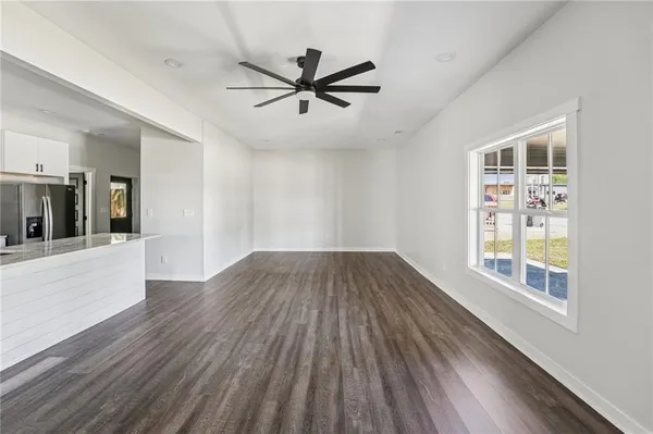 wooden floor in an empty room with a window