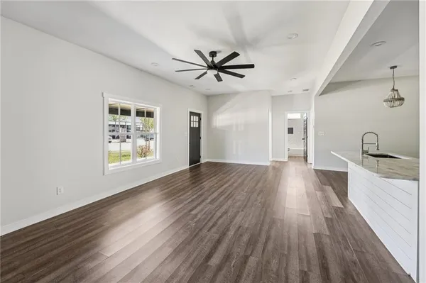 a view of a livingroom with a hardwood floor and a ceiling fan