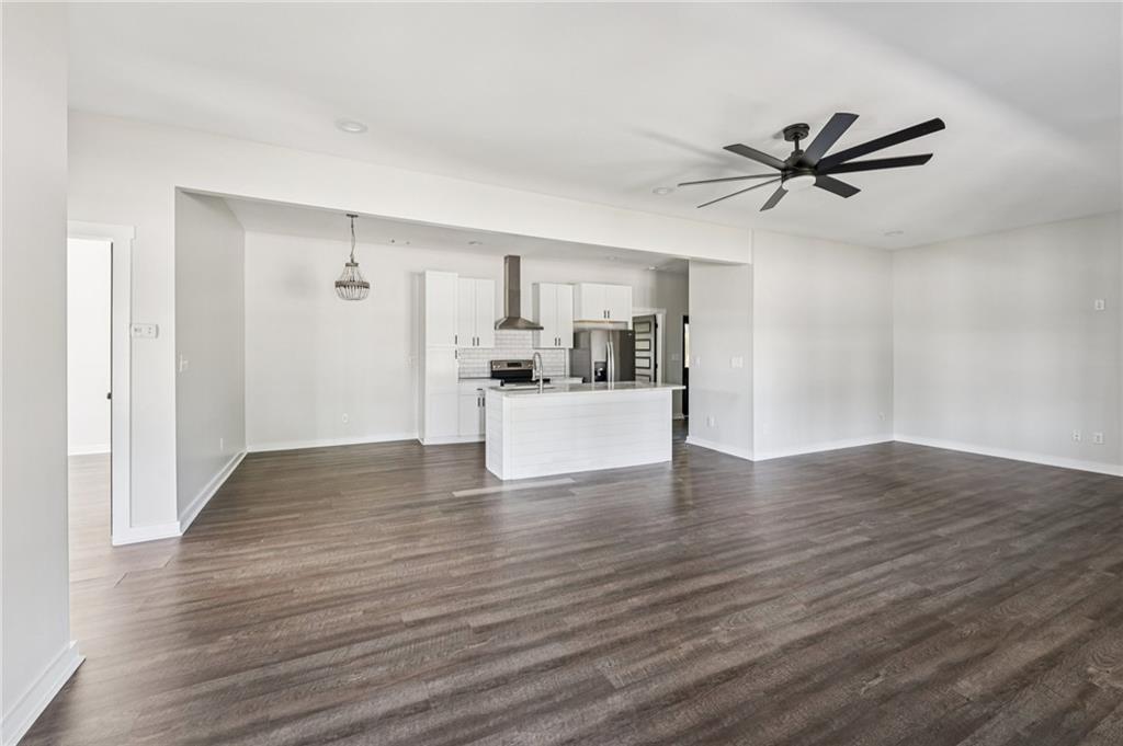 212 Hamilton Avenue Bremen, GA 30110 - Photo 10 of 65 a view of a livingroom with a hardwood floor and a ceiling fan